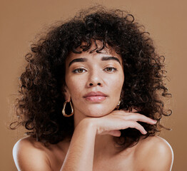 Makeup, confident and portrait of a woman with hair care, skincare and beauty against a brown studio background. Face, cosmetic and young girl model with a curly afro, cosmetics and empowerment - obrazy, fototapety, plakaty