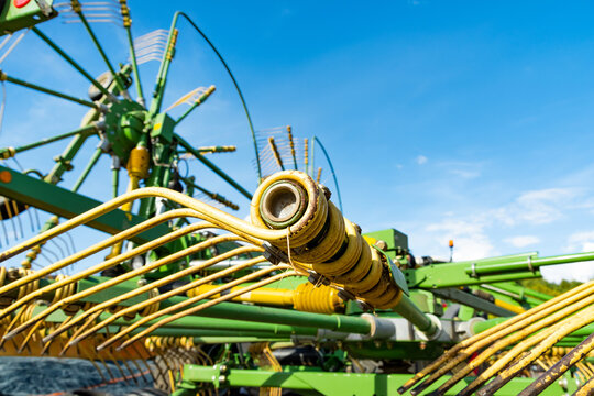 Close-up of a tedder against blue sky