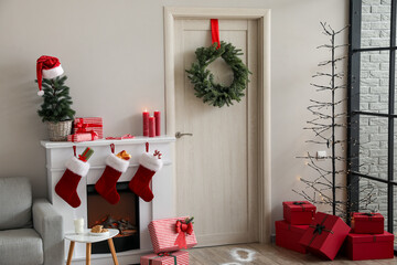 Obraz premium Interior of living room with wooden door, fireplace and Christmas decor