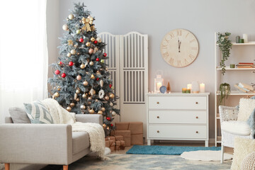 Interior of living room with clocks, drawers and Christmas tree