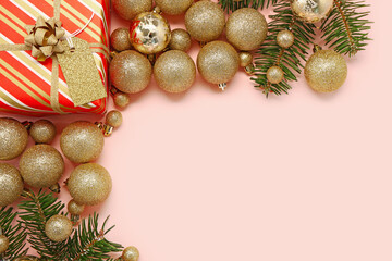 Composition with Christmas gift, balls and fir branches on pink background