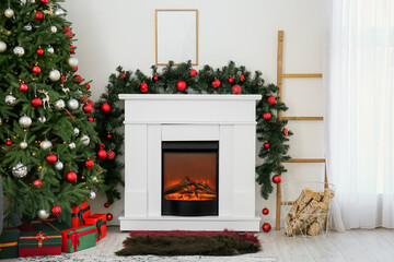 Interior of living room with fireplace, fir branches and Christmas tree