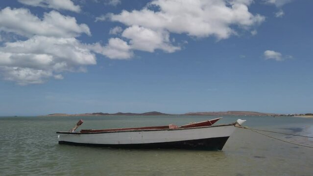 Cabo de La Vela, Guaijra Colombia - wooden fishing boat in caribbean sea ocean seascape with blue sky and clouds typical of south America  
