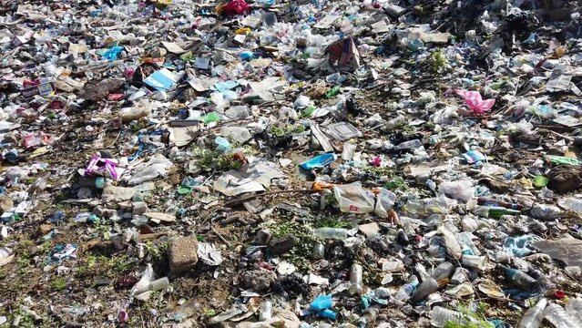 Colombia Uribia Gujiara 2022 Illegal and illegal waste dump outdoor  in nature with plastic and various pollutants in nature near a puddle of water  - Save the planet and climate change concept 