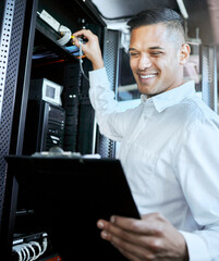 Server room, IT support and database with a man programmer working on a mainframe in a data center....