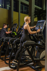 Fototapeta na wymiar Elliptical trainer young woman machine, for fit exercise for activity recreation learning, room elliptical. Cardio club living, trainer