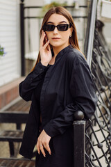 Obraz premium Cheerful beautiful brunette woman in good mood use phone outside
