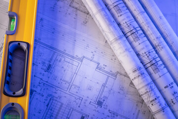 Contractor theme. Plans,  notebook and tool kit of the contractor: yellow hardhat, libella, saw and...