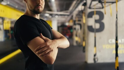 Closeup of handsome gym buff crossing hands on chest, active lifestyle promotion