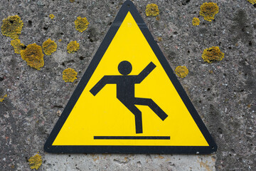 Sign beware slippery floor on a wall