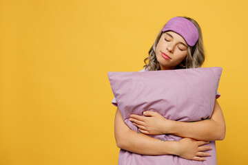Calm young serene peaceful woman she wears purple pyjamas jam sleep eye mask rest relax at home...
