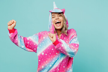 Young cheerful ywoman 20s she wear domestic costume with hoody and animals ears gesticulating hands dance on pajama party isolated on plain pastel light blue cyan background. People lifestyle concept.