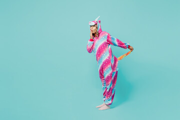 Full body side view shocked fun young woman 20s wear domestic costume with hoody and animals ears show tail cover mouth isolated on plain pastel light blue cyan background. People lifestyle concept.