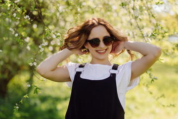 Portrait of young beautiful attractive woman at summer green park