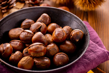 Chestnuts on a wooden table.
Tasty chestnuts image.