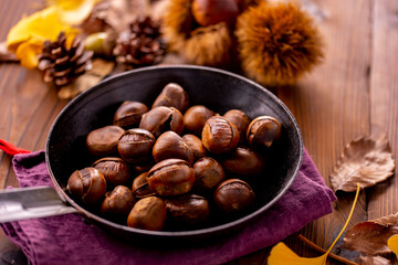 Chestnuts on a wooden table.
Tasty chestnuts image.