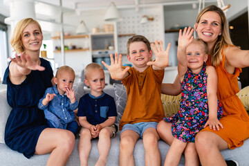 Obraz premium Portrait of happy big family. Gay couple of women smiling and having fun with children at home