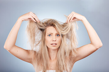 Hair, portrait and woman in studio for hair care, problem and fail or hair loss against grey...