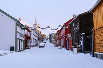 Street with wooden buildings in the town Roeros, Norway