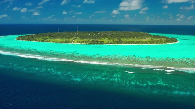 Aerial view on Thoddoo beautiful tropical fruit island with palm and fruit trees from above. Maldives, whole island Thoddoo.