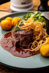 Beef medallion with baked potatoes and salad