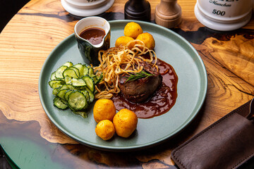 Beef medallion with baked potatoes and salad