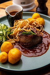 Beef medallion with baked potatoes and salad