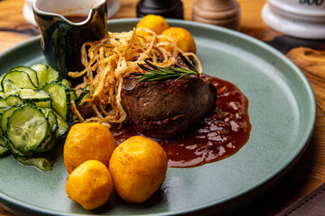 Beef medallion with baked potatoes and salad