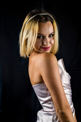 Naklejka premium Beauty portrait of a gorgeous young woman in a silk robe smiling seductively.