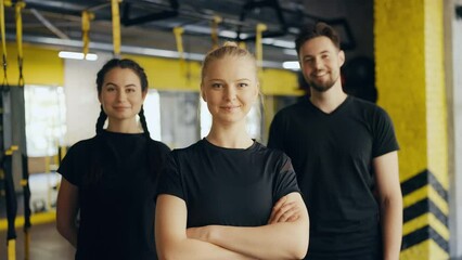 Portrait of confident gym people posing together, team of athletes, training