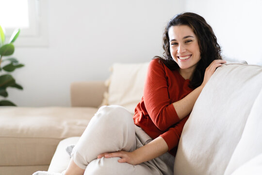 Young happy woman enjoying time of relaxation at home