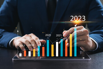 Businessman analyzes profitability of working companies with digital augmented reality graphics,...
