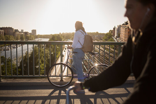 Man riding bicycle on bridge
