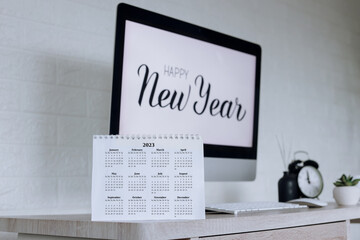 Fototapeta na wymiar 2023 calendar with Happy New Year text on computer screen on the background