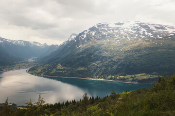 Fototapeta na wymiar Clouds above mountain and fjord