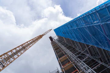 Fototapeta na wymiar Low angle view of crane and construction site