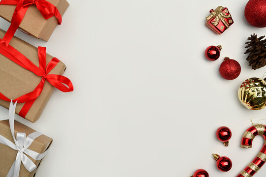 Christmas Gift Boxes, Pine Cone And Gold Ornaments On White Background. Flat Lay, Top View With Copy Space