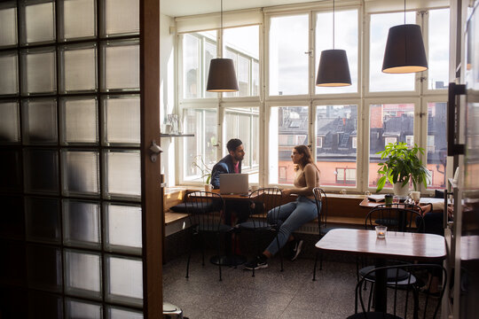 Coworkers talking in office break room