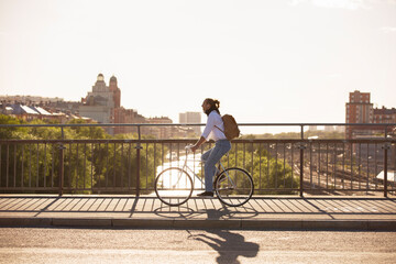 Man riding bicycle on bridge