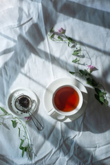 Spring teatime, rustic flatlay, tea cups from above on a wrinkled cloth background with copy space