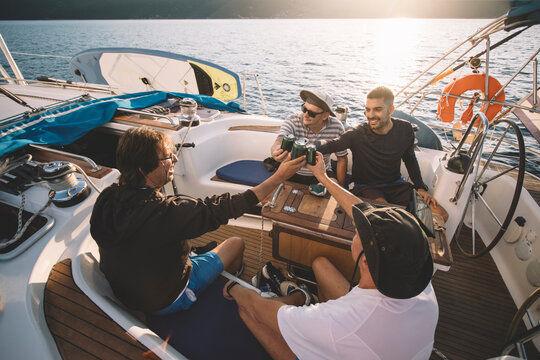 Group of friends enjoy sailing with beer 