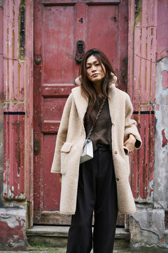 Woman In Coat By Weathered Door