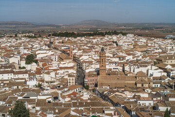 Obraz premium the city of Antequera. tight buildings, white houses, monuments, churches view from the castle hill. Peña de los Enamorados hills and rock in the background