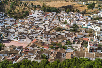 the city of Antequera. tight buildings, white houses, monuments, churches view from the castle hill. Peña de los Enamorados hills and rock in the background