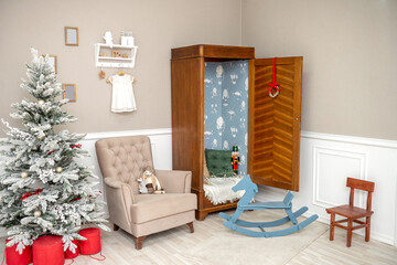 Cozy children room decorated for Christmas with a decorated Christmas tree and a wardrobe with toys