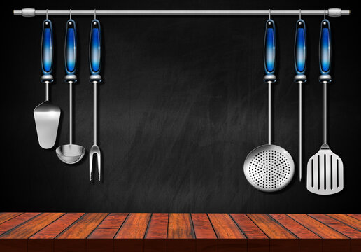 Empty wooden kitchen counter (wooden table for products display) with a set of kitchen utensils and a blackboard with copy space on background.