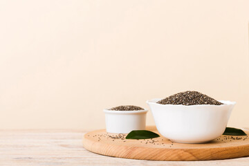 Chia seeds in bowl on colored background. Healthy Salvia hispanica in small bowl. Healthy superfood