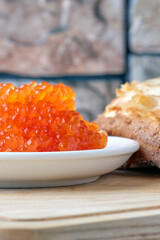 red caviar on a white plate, shallow depth of field