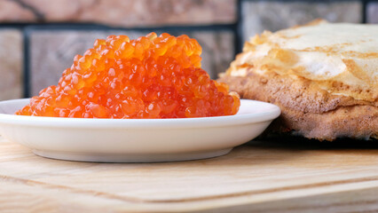 red caviar on the background of pancakes, shallow depth of field