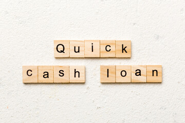 quick cash loan word written on wood block. quick cash loan text on table, concept